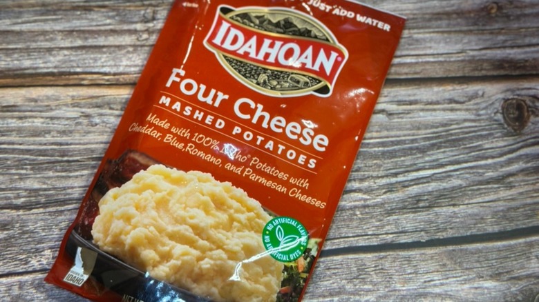 Idahoan Four Cheese Mashed Potatoes against wooden background