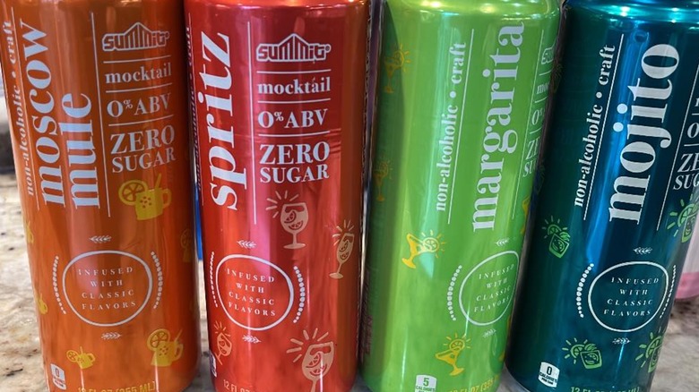 Four brightly colored cans of summit canned mocktails