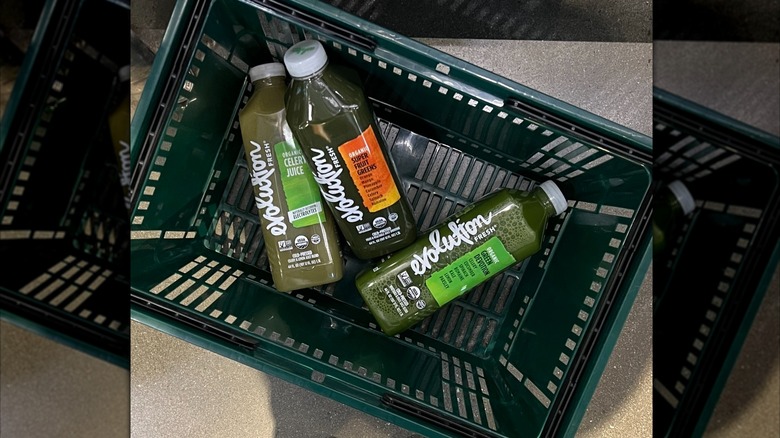 Top down view of Evolution Fresh bottles in store basket