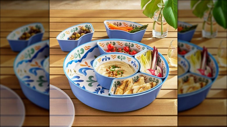 Member's Mark 6-Section Bamboo Melamine Serving Platter with Lazy Susan Base and Storage Lid with snacks on wooden slated table