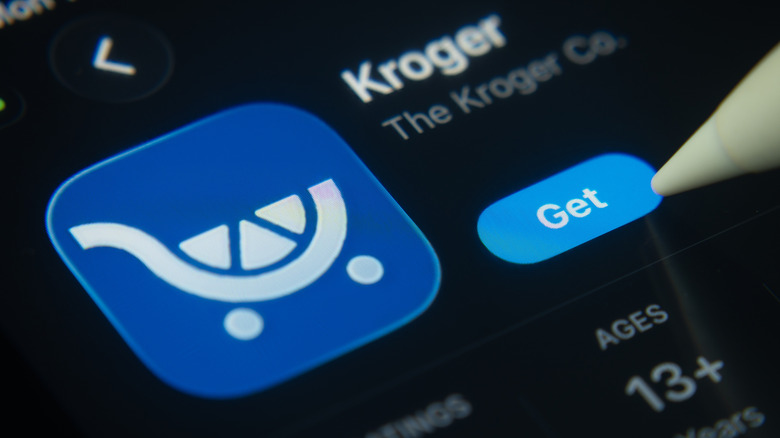 Stylus tapping the Kroger app on a smartphone