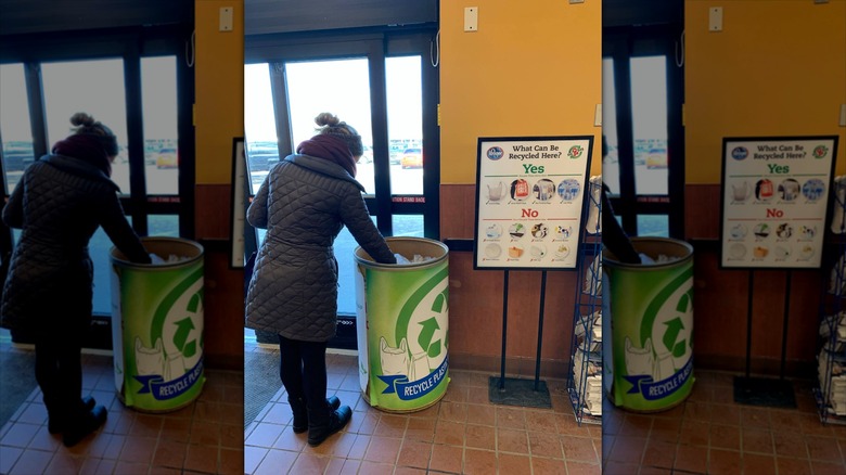 Woman recycling plastic in Kroger recycling bins