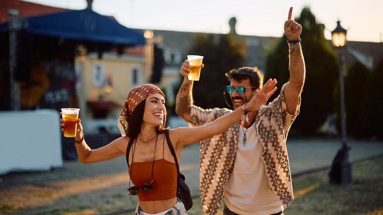 Couple drinking beer outside