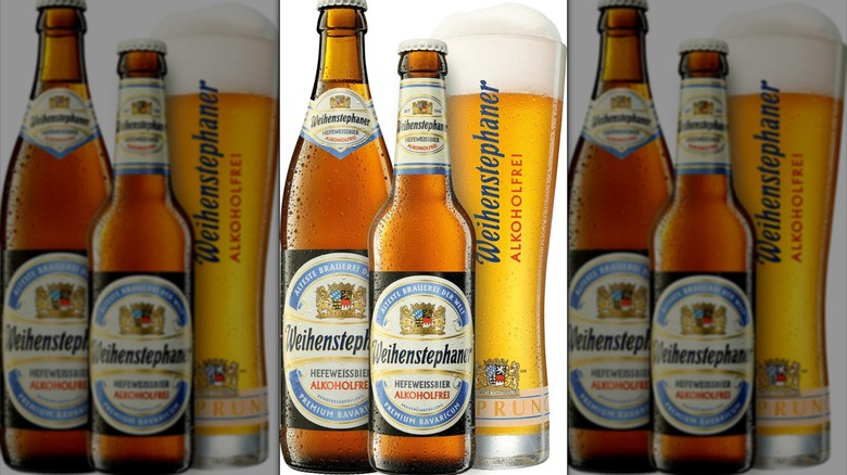 Bottles and glass of Weihenstephaner Alkoholfrei beer on a white background