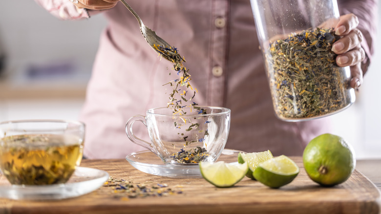 Person cooking with dried herbs