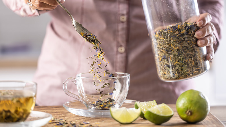Person cooking with dried herbs