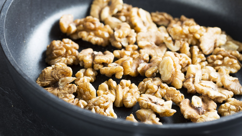 Toasted nuts in a black ceramic pan