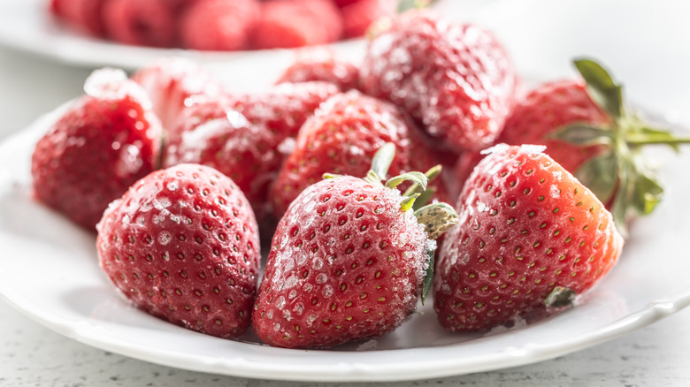 Frozen strawberries on plate