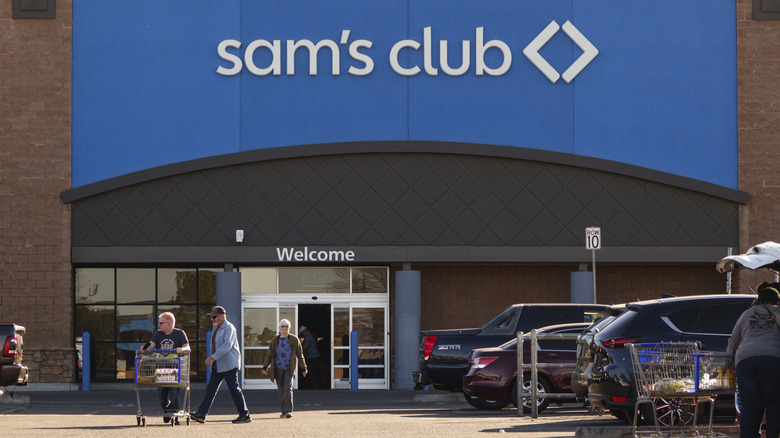 Sam's Club sign and shoppers with groceries in carts