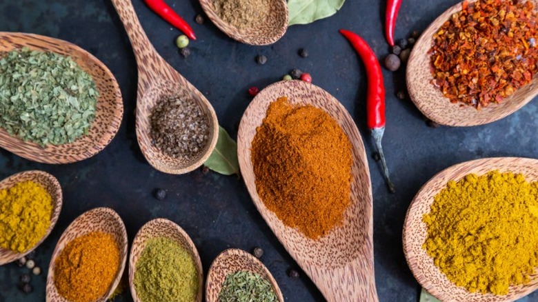 various spices on wooden spoons