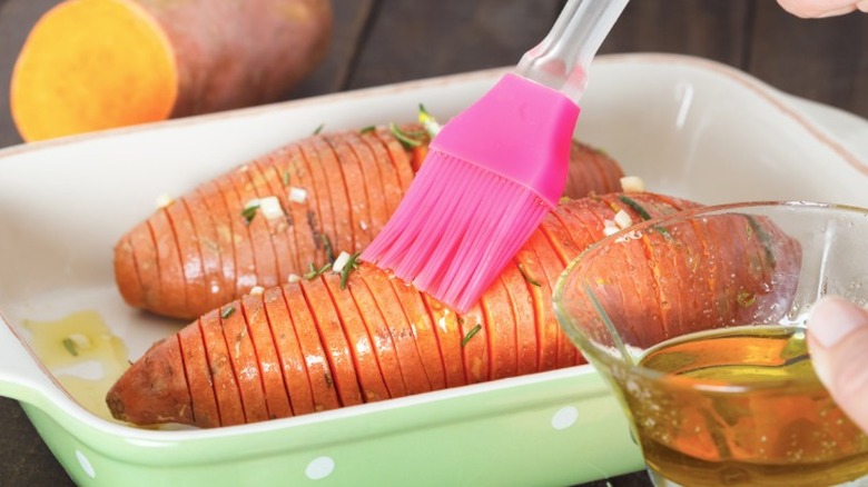 potatoes being brushed with oil