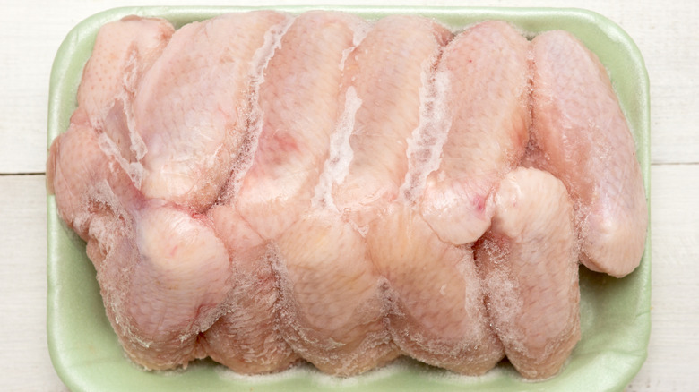 Frozen chicken wings in a tray