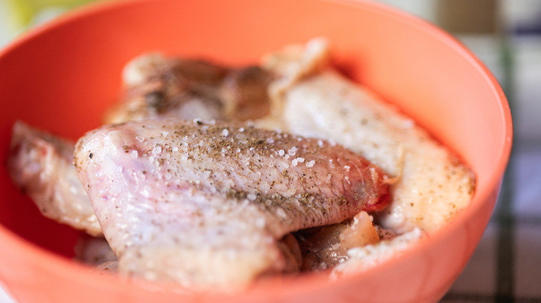 Seasoning raw chicken wings