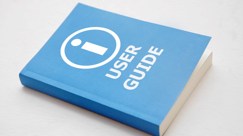Blue user guide book on white background, instruction manual