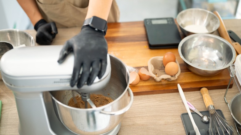 Baker mixing cookie dough with a stand mixer