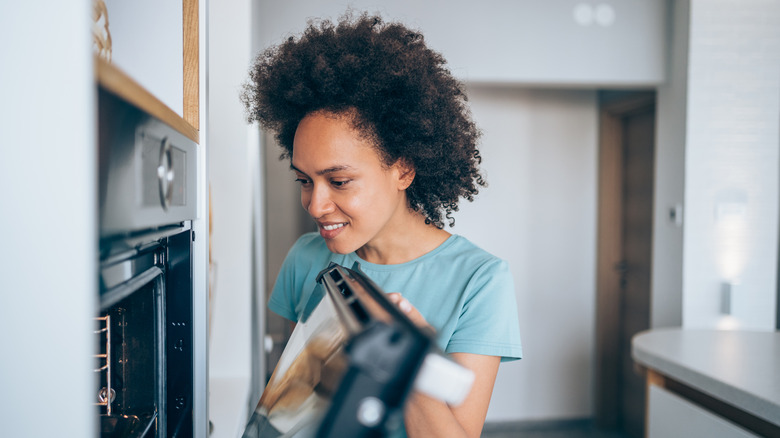 Woman looking into an oven