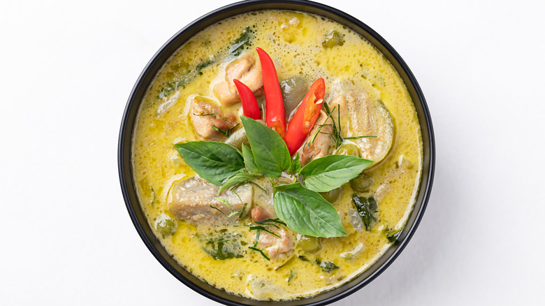 Thai green curry with chicken in a black bowl