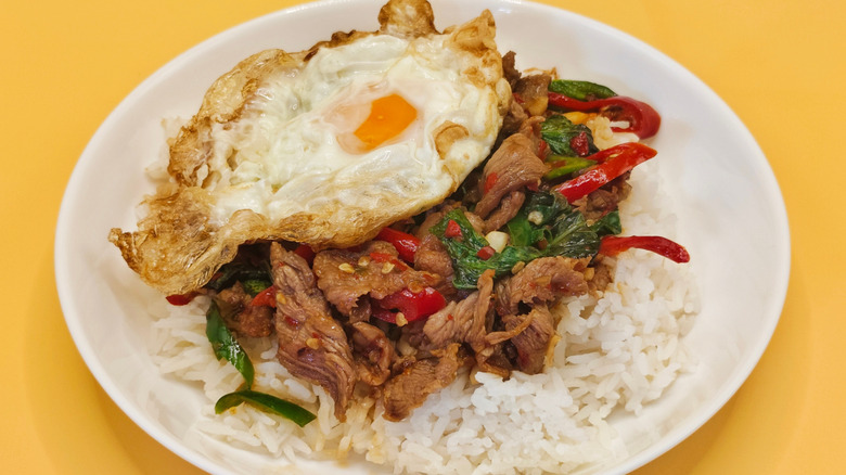 Spicy stir-fried beef with holy basil, served with a fried egg