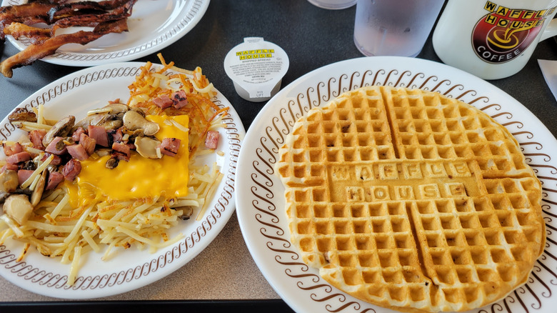 plate of Waffle House pecan waffles with hashbrowns, bacon, and coffee