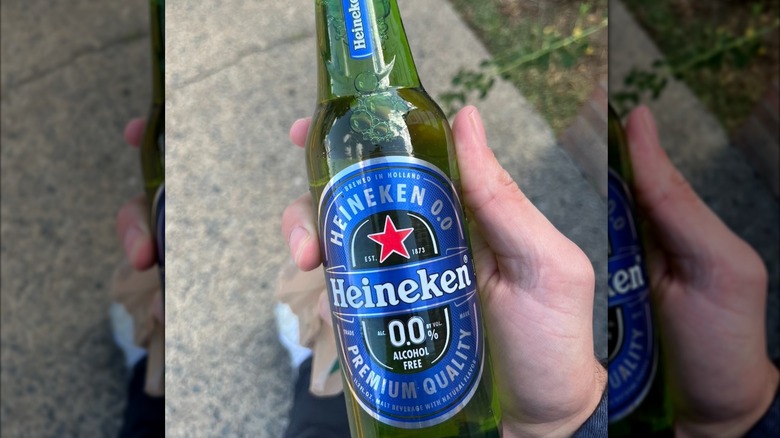 Hand holding a bottle of Heineken 0.0