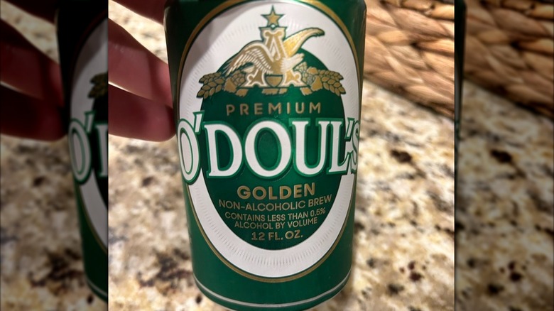 Hand holding a can of O'Douls