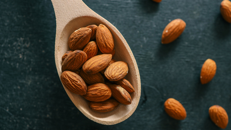 Almonds on a wooden spoon