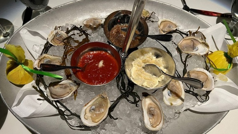 Oysters on the half shell with sauces and lemon
