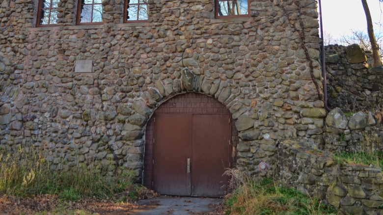 old stone building with red door