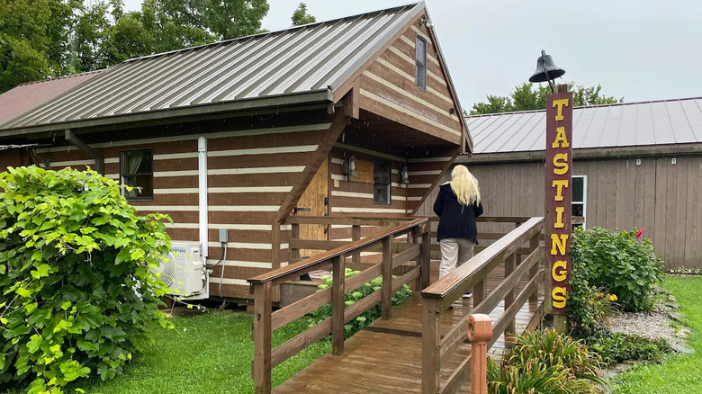 log cabin with ramp and sign saying tastings