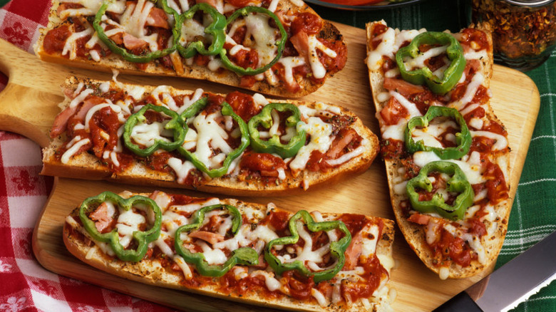French bread pizzas on boards