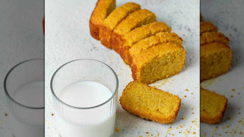 Cornbread slices beside a small glass of milk
