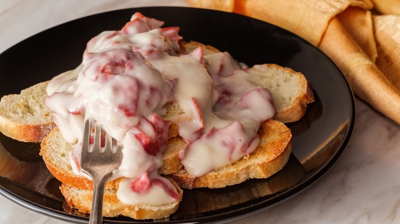 Creamed and chipped beef on sliced toast on marble kitchen table