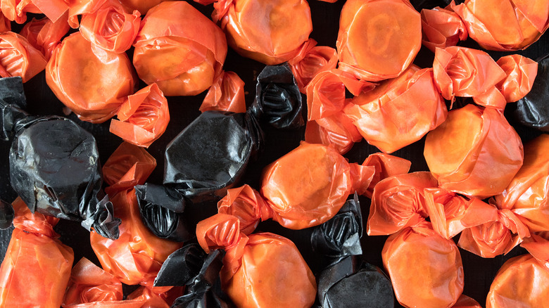 a closeup of peanut butter kisses candy in their orange and black wrappers