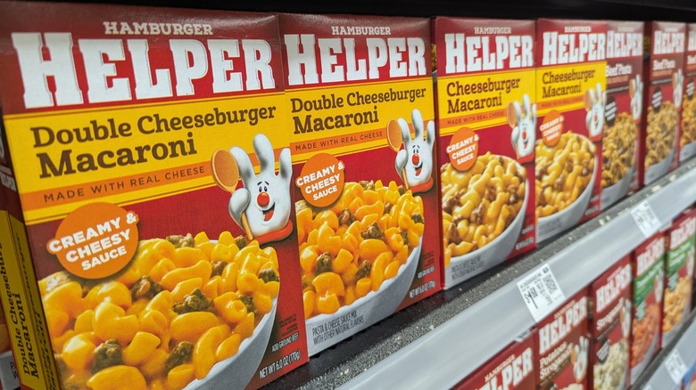 Row of Hamburger Helper boxes lined on grocery shelf