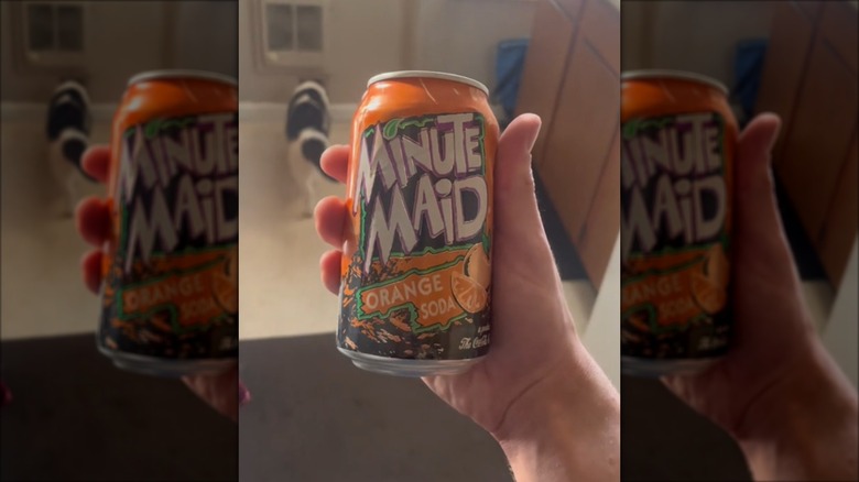 Minute Main Orange Soda can in person´s hand