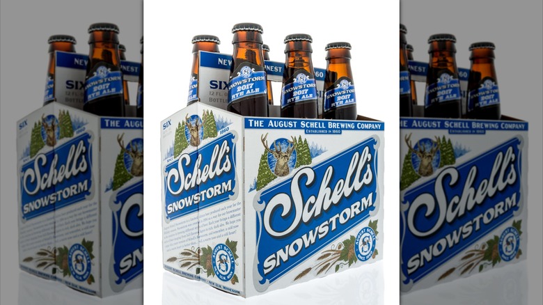 A six-pack of Schell's beer on a white background, mirrored