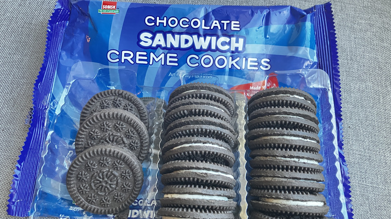 Rows of chocolate sandwich cookies atop a blue and white package