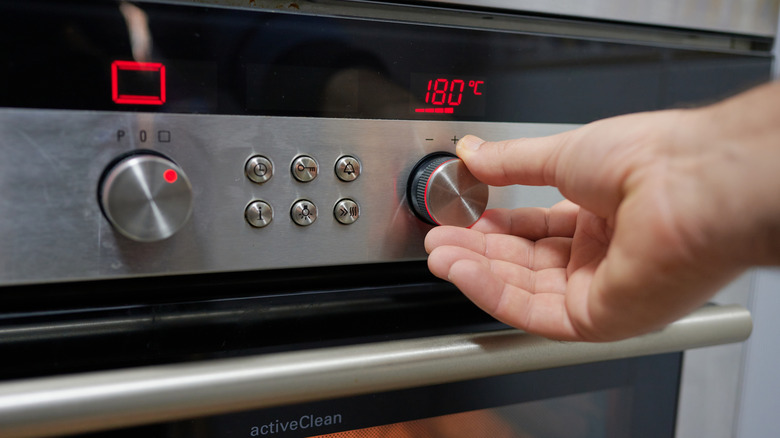 Person setting oven temperature
