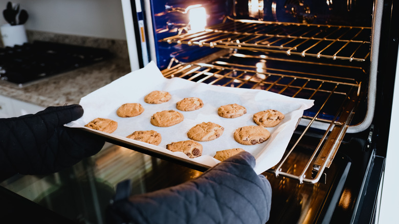 Cookies being placed on an oven rack