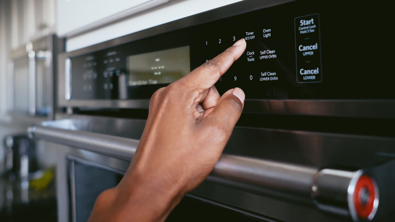 Woman setting the oven