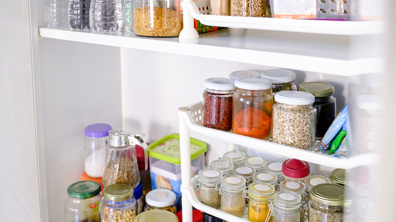 A pantry stocked with containers of various staples