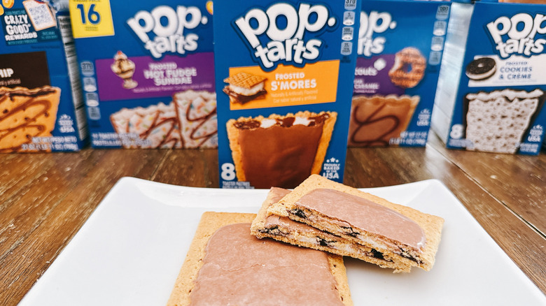 Frosted s'mores pop-tarts cut on a plate with package in background