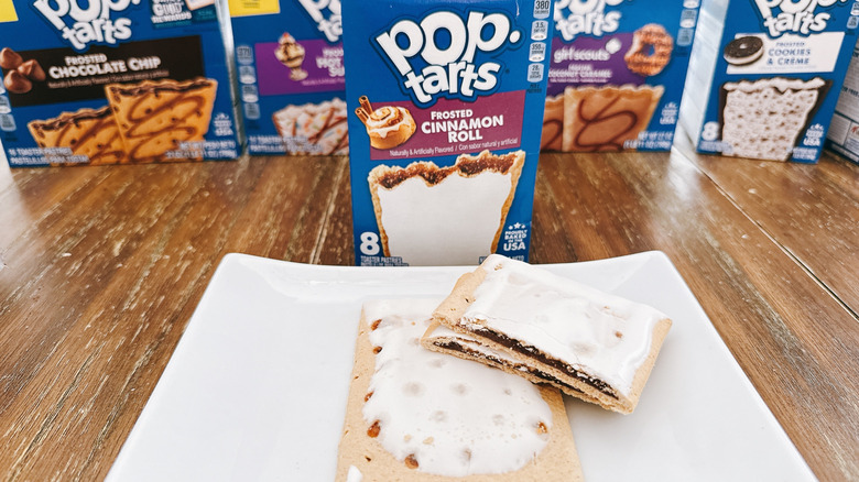 Frosted Cinnamon Roll Pop-Tart cut on a plate with package in background