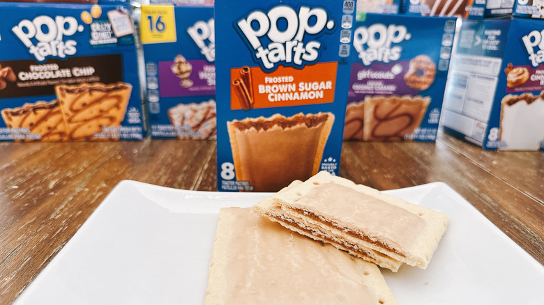 Frosted Brown Sugar Cinnamon Pop-Tarts cut on a plate with package in background