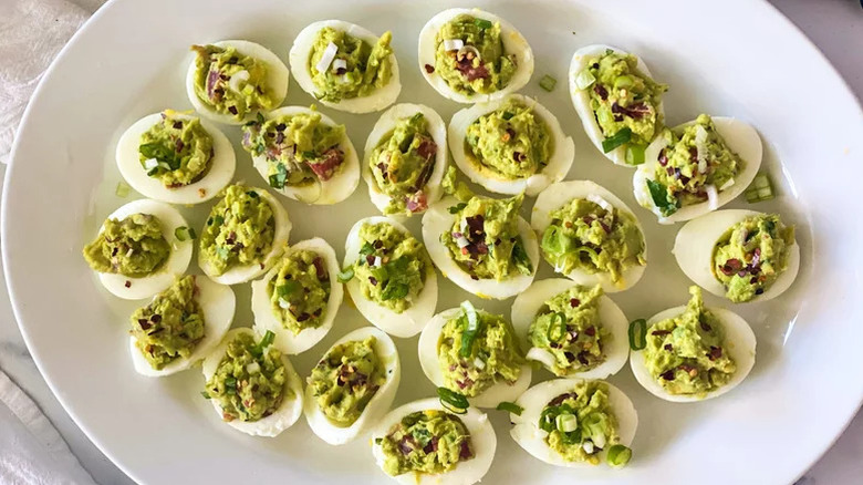 Guacamole deviled eggs on a plate