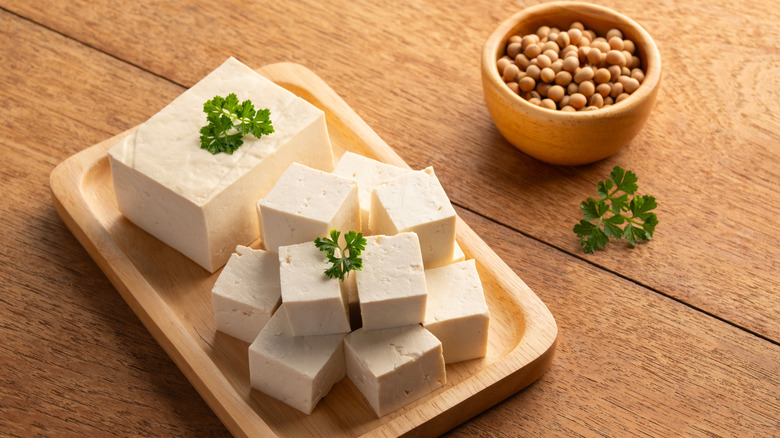 Tofu cubes on a wooden board