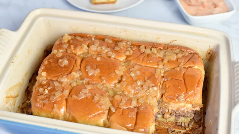 Hamburger sliders in a white baking dish