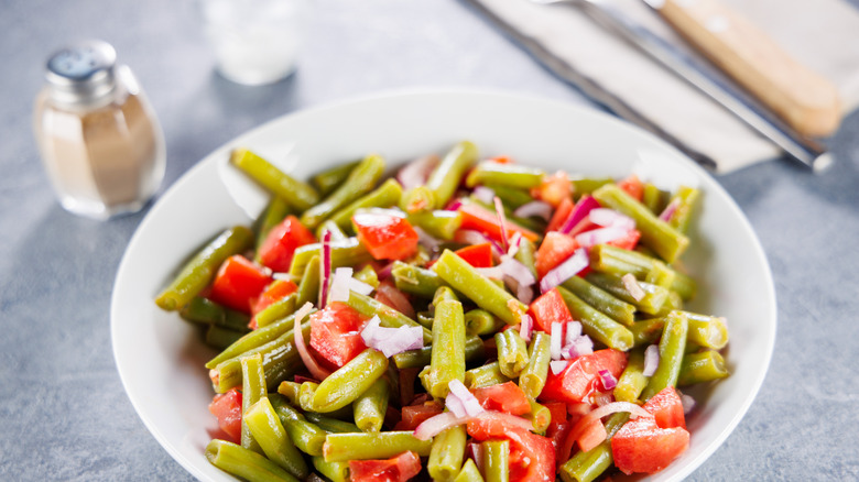 Tomato and bean salad in a white bowl