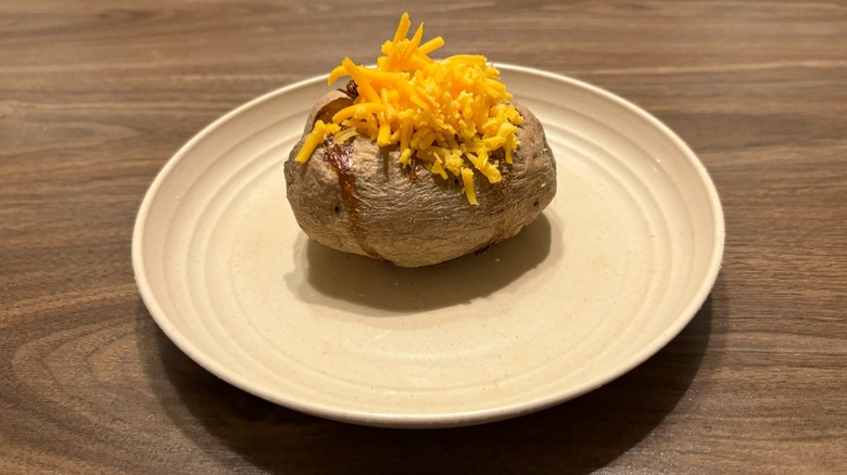 baked potato with cheddar cheese on plate