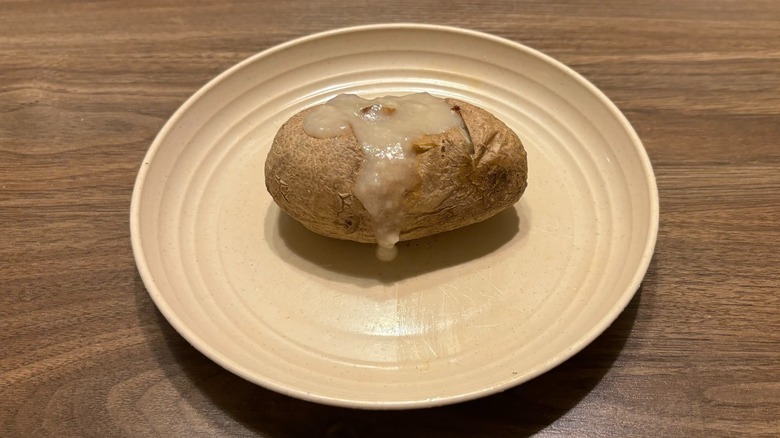 baked potato with gravy on plate